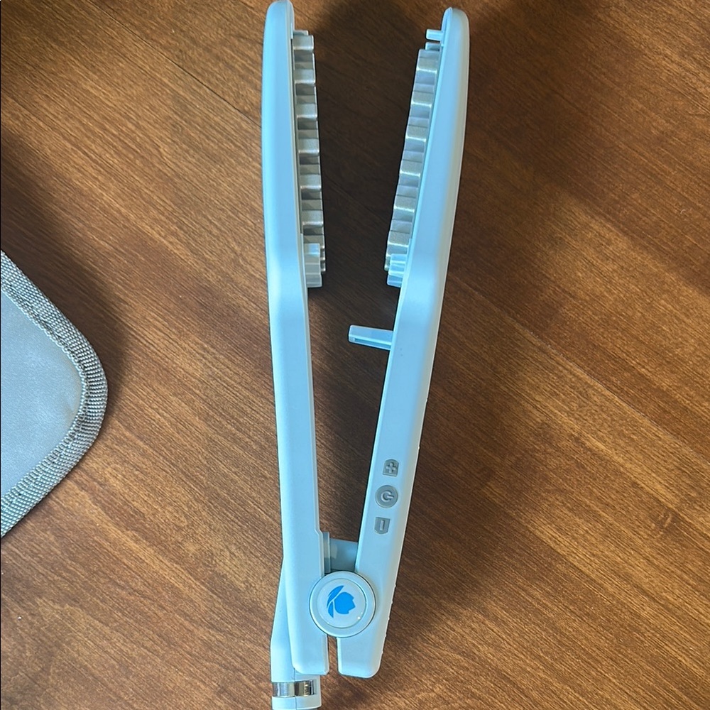 Powdered blue Voloom 1.5” hair volumizing iron. Comes with travel bag!